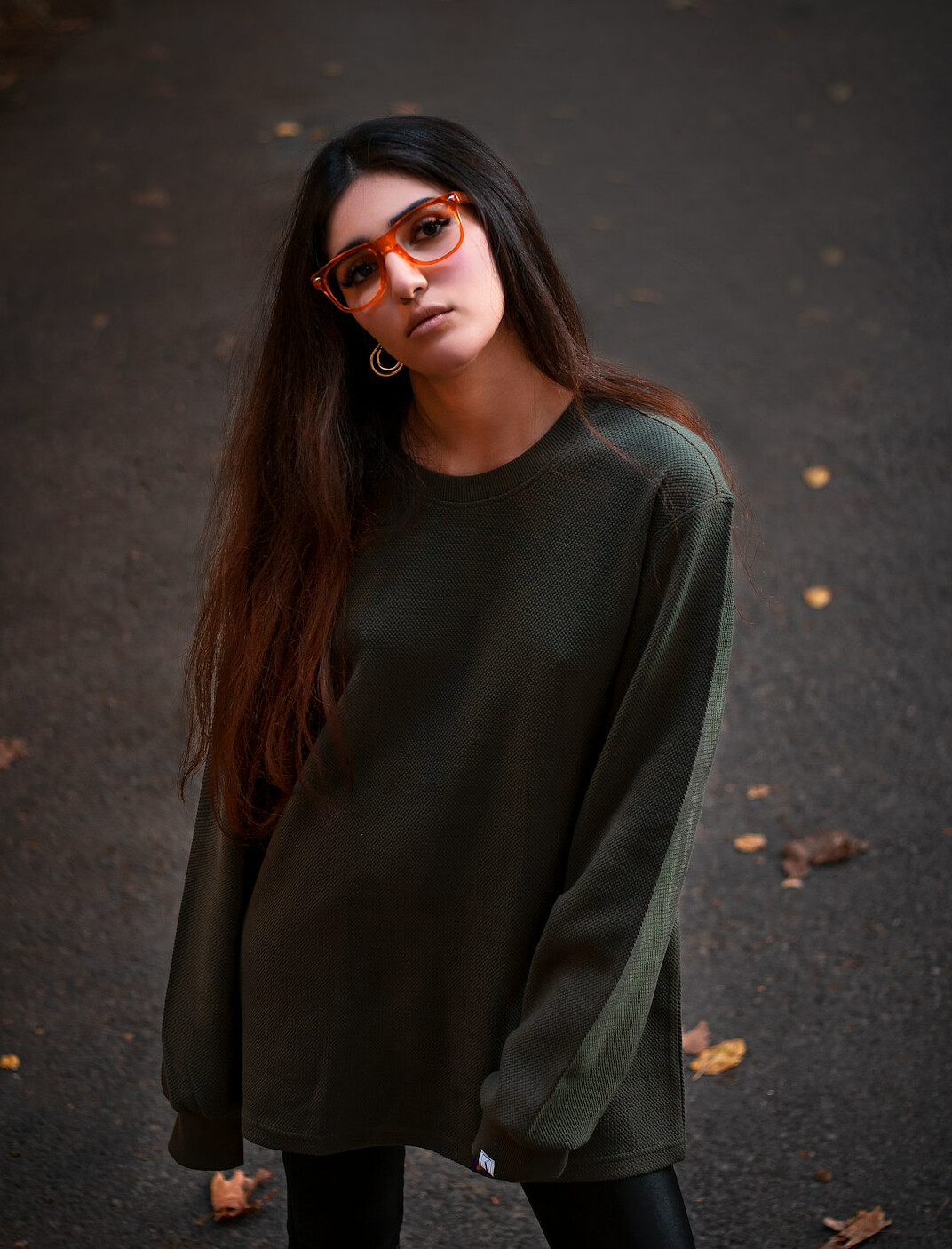 Portrait of a Mexican woman with a short bob haircut in a green sweater
