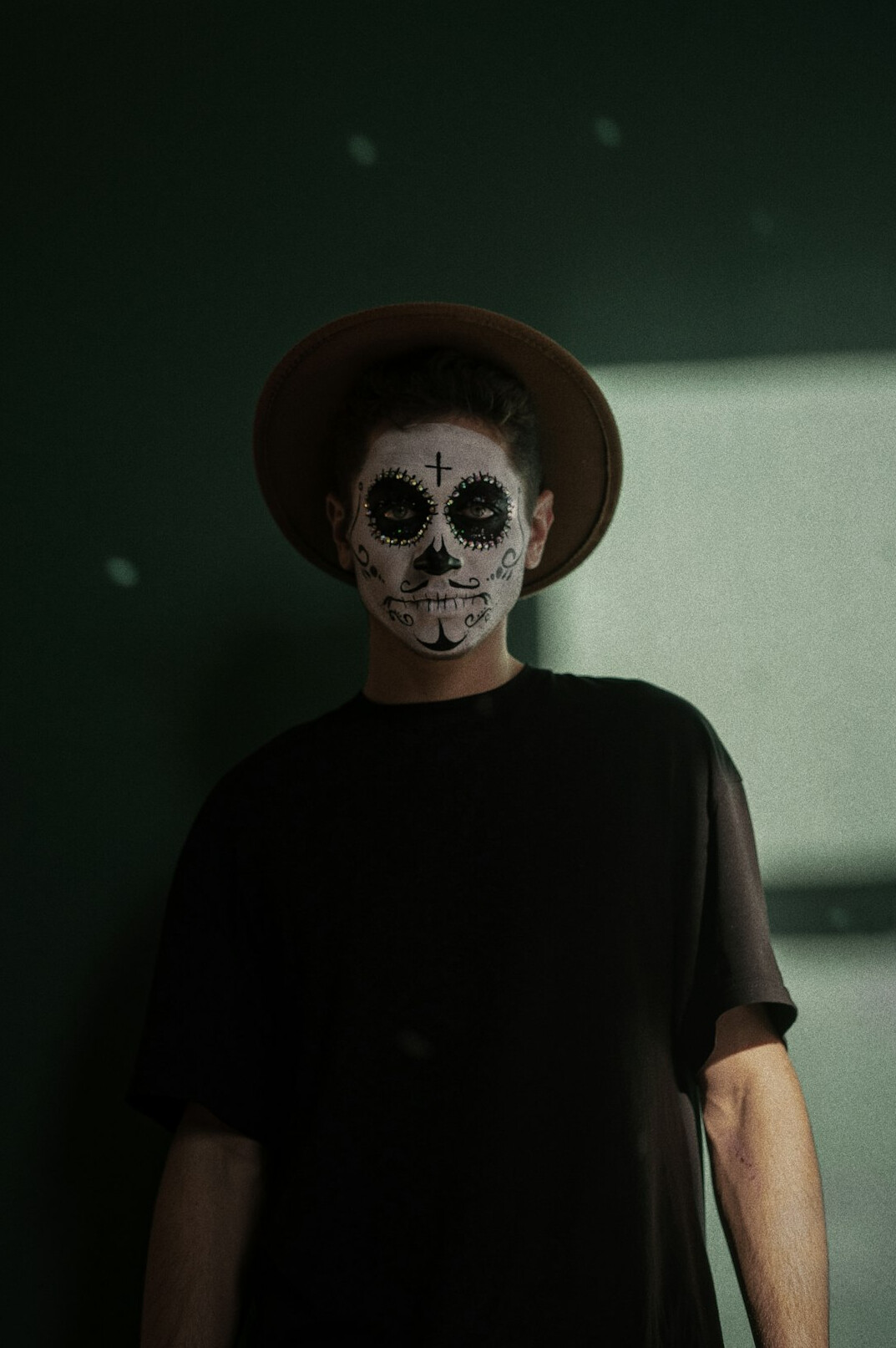Portrait of a Mexican man with a short beard wearing a dark shirt
