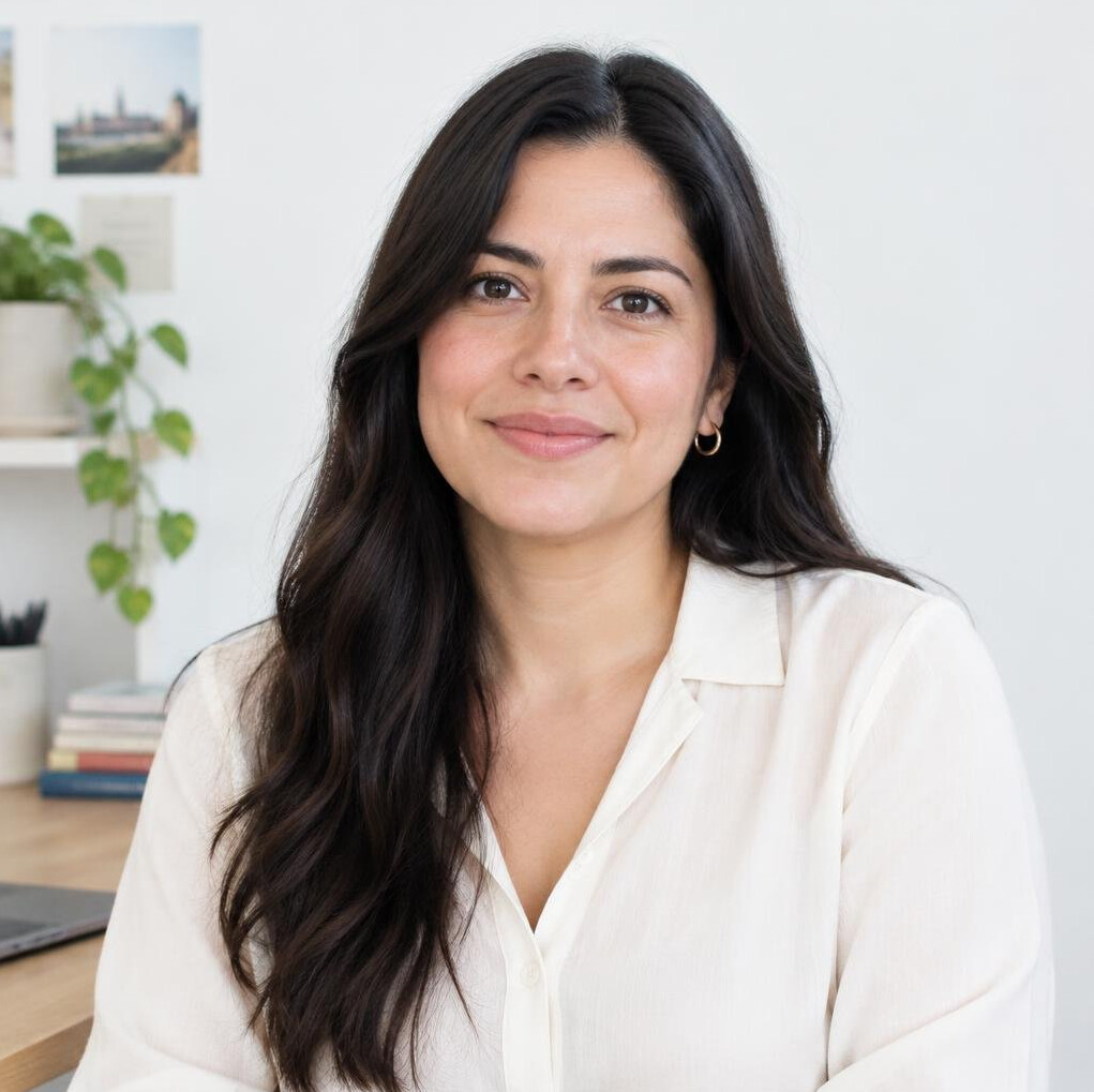 Portrait of a Mexican woman with long dark hair smiling in an office