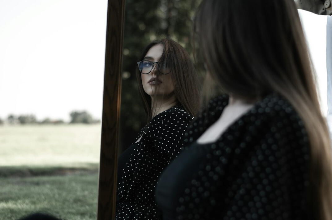 confident person smiling in mirror